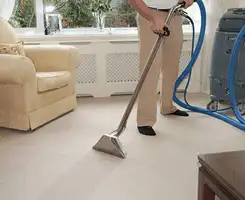 Carpet cleaning professional removing dirt and stains with a hot-water extraction tool in a home, Pembroke Pines, FL.